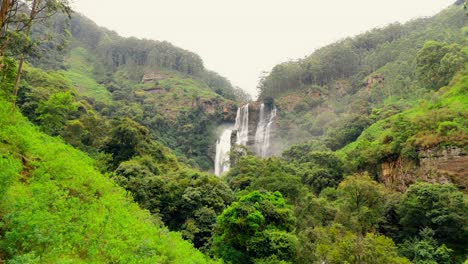 witness the breathtaking beauty of ramboda waterfalls in nuwara eliya, sri lanka, captured from a stunning aerial perspective.