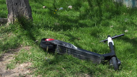 Close-up-of-electric-scooter-fallen-on-roadside