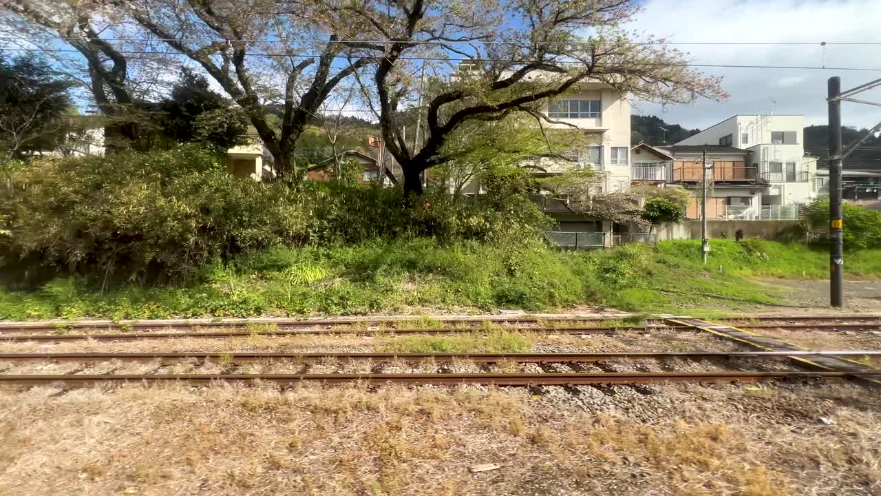 Looking sideways out of train window riding through rural scenery