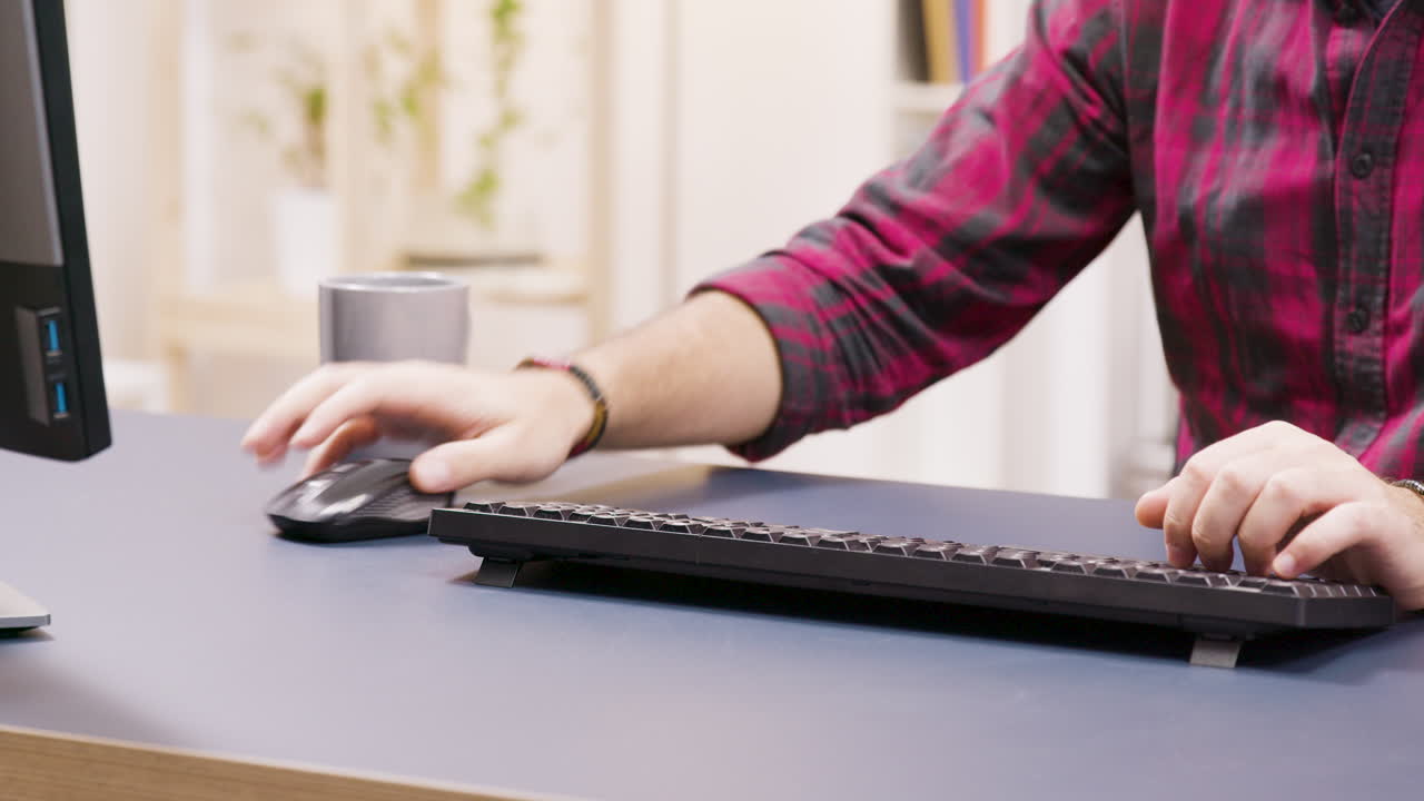 Working at a desk with a computer and peripherals