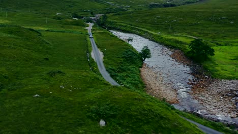 Vista-Aérea-Drone-Shot-of-Motorbike-Riding-Through-Glen-Etive-02