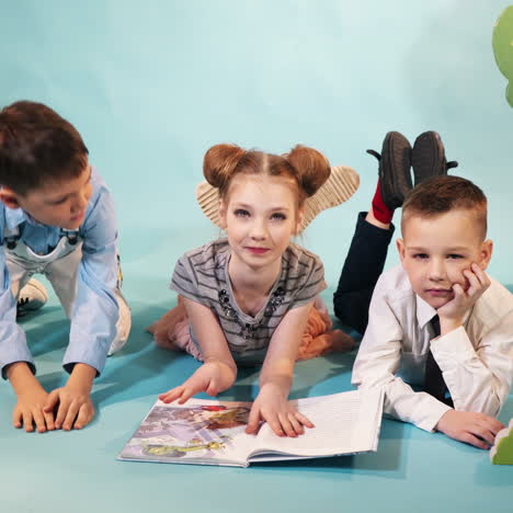 funny children read a book on decorative background. studio shooting of children square video