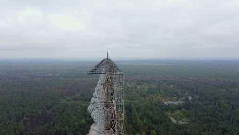 enormous duga radar antenna in the forest near chernobyl in pripyat, ukraine - orbiting drone shot