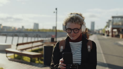 girl with prosthetic arm listening to music on walk