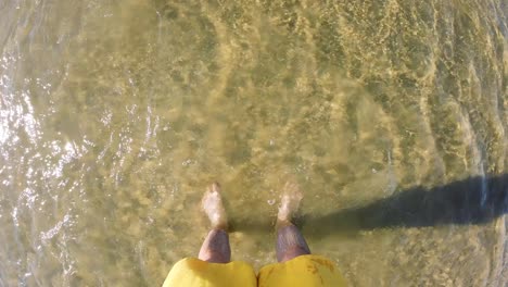 man's legs in sea's water at shore. summer vacation in turkey.
