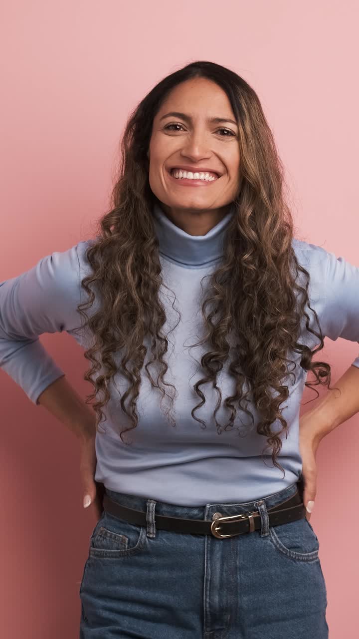 Happy hispanic woman smiling at the camera. Vertical footage