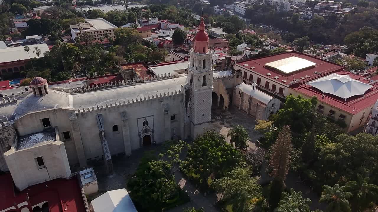 Drone View Flying Alongside a Historic Church in Cuernavaca City Center, Capturing the Rich Architecture and Vibrant Surroundings