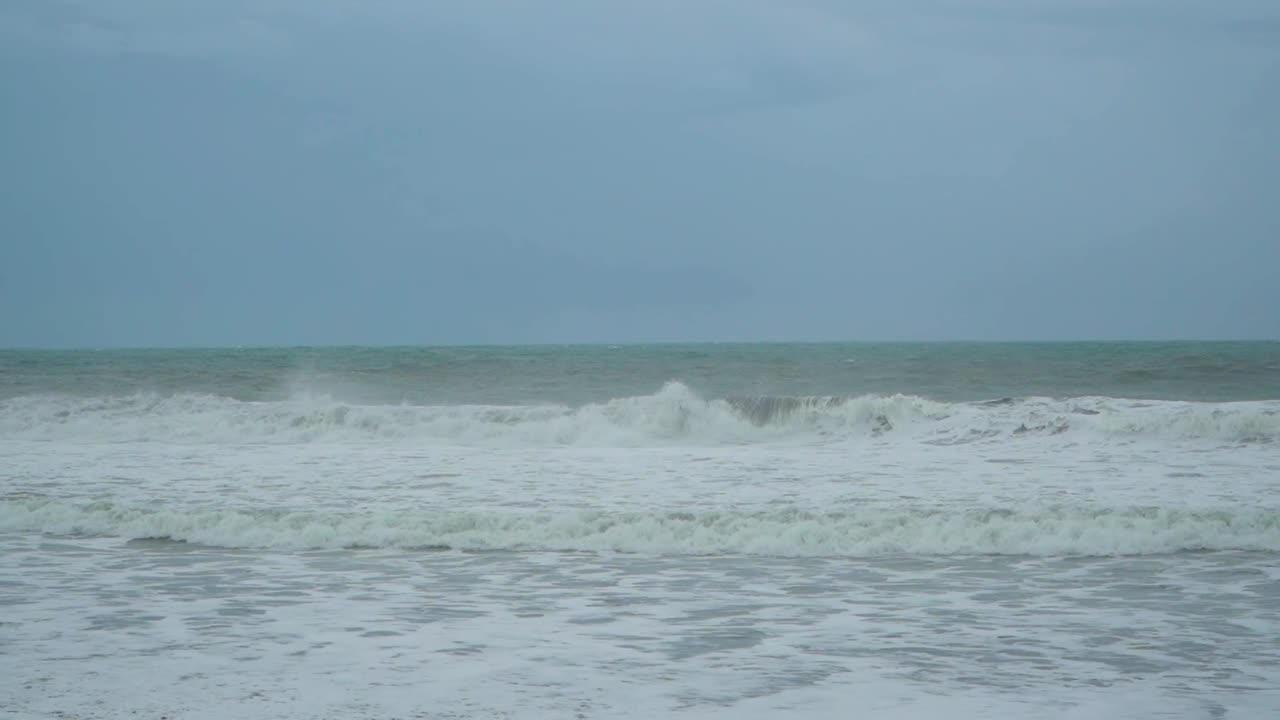 Waves crashing on Purworejo empty beach, Central Java. Indonesia. Static view