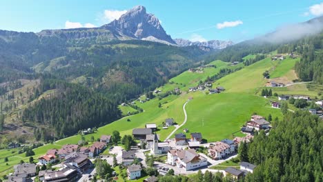 nestled within the expansive green meadows, the picturesque village of antermoia offers a serene retreat, with the imposing peitlerkofel, or sass de putia, majestically standing guard in the backdrop