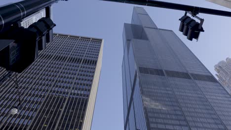 pan and tilt shot capturing the imposing willis tower against the clear blue chicago sky