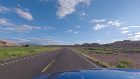 driving west on utah state route 24 away from the town of hanksville - driver point of view