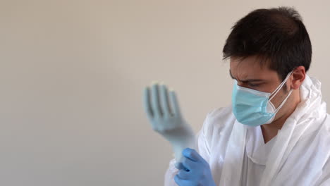 Doctor-in-PPE-suit-putting-glove-on-latex-glove