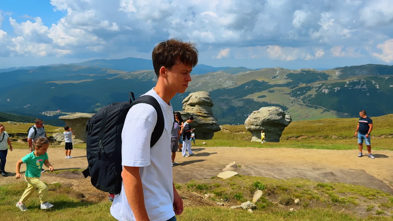 Visitors near Sphinx rock formation in Bucegi Mountains. Hikers and visitors enjoying the iconic Sphinx rock formation in Bucegi Mountains, Romania