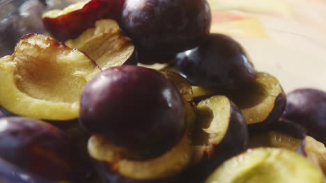 close-up of plum slices stacked in a glass bowl