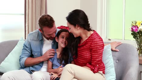 Happy-family-discussing-on-sofa