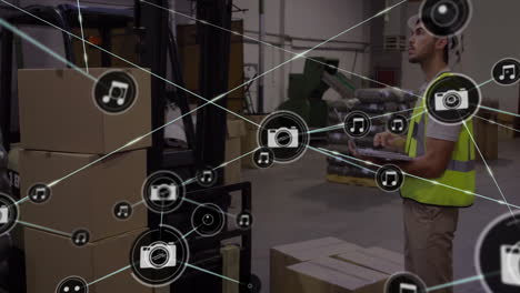 using tablet, warehouse worker with connected devices and multimedia icons animation