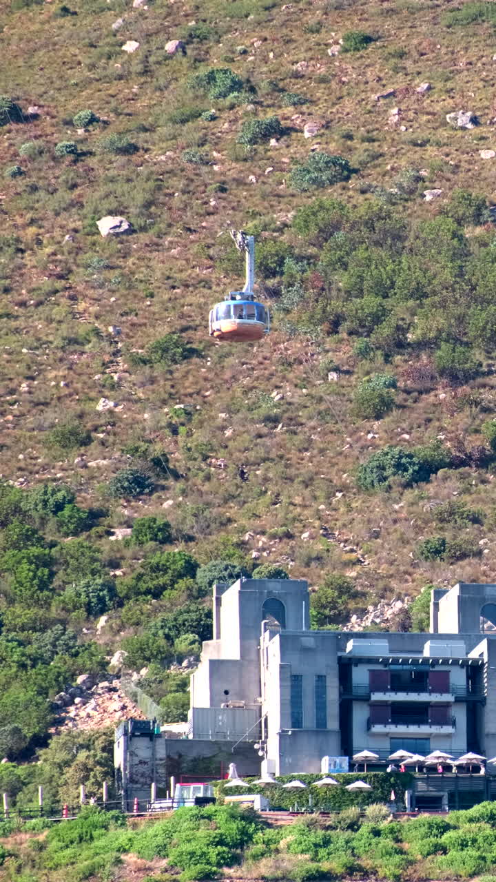 VERTICAL - Cable car descends toward lower station at famous Table Mountain