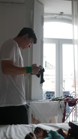 person doing laundry in a bedroom