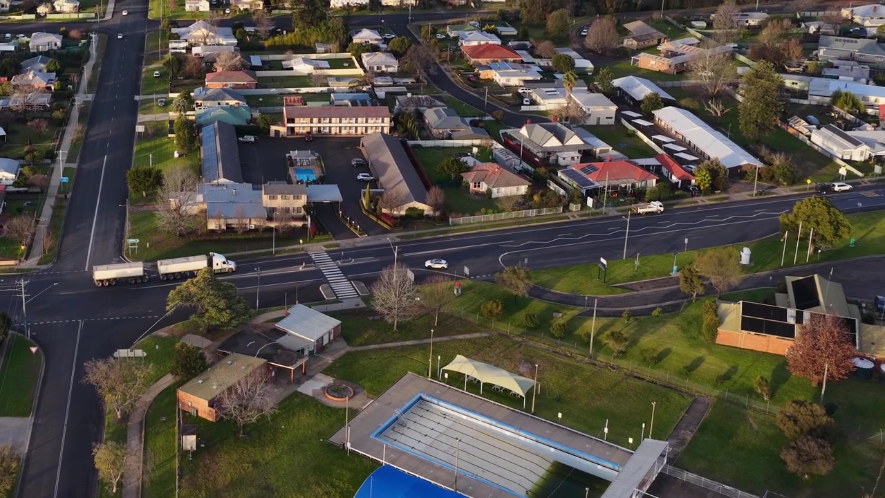 Ripresa aerea con drone di un quartiere residenziale con case e una piscina in Australia.