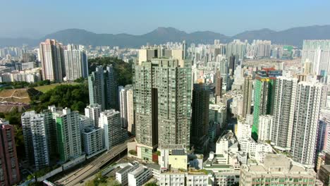 Aerial-shot-of-Downtown-Hong-Kong-mega-residential-skyscrapers-and-traffic,-on-a-beautiful-day