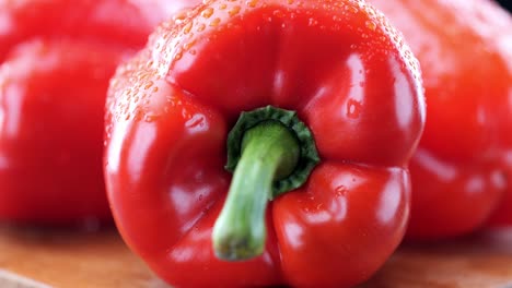 Fresh-red-pepper-on-wooden-chopping-board,-extreme-close-up-pan