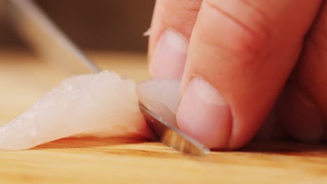 chef slicing fish fillet