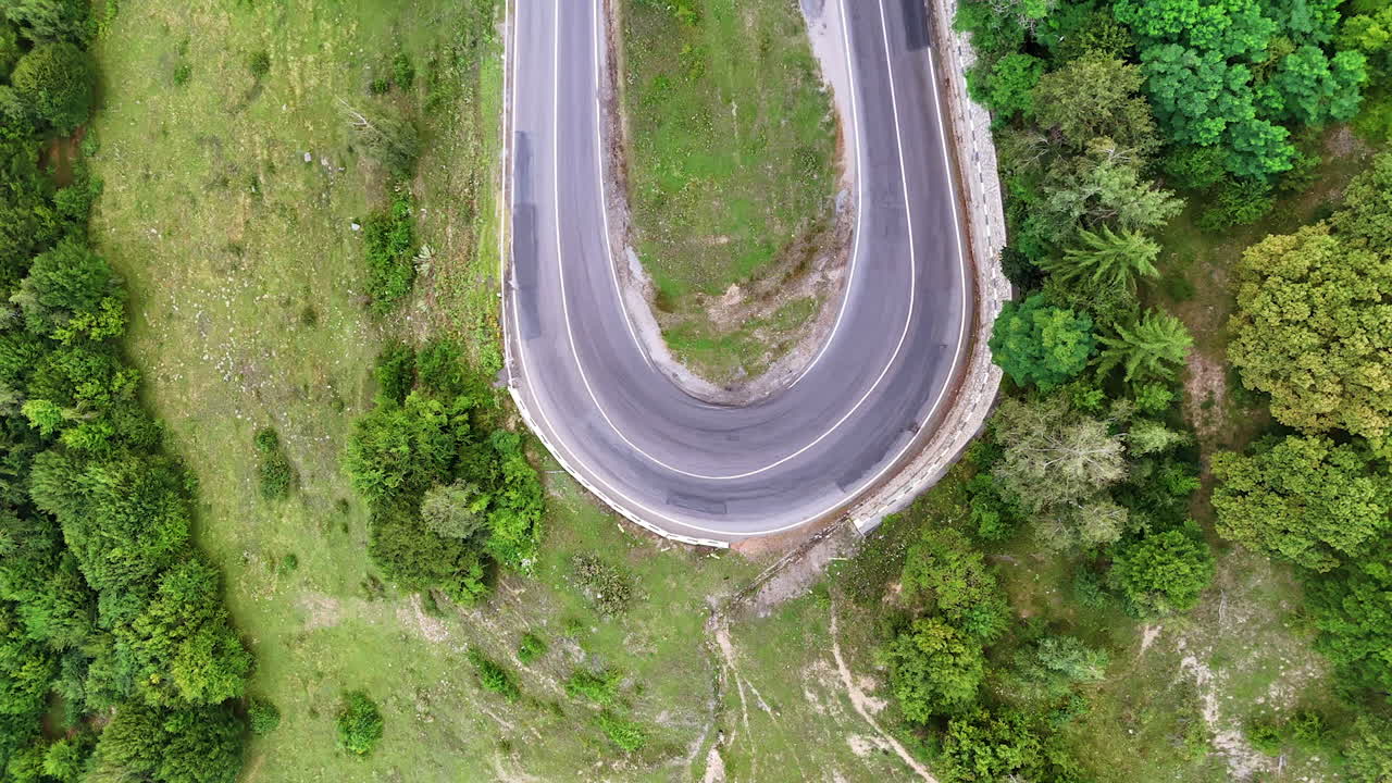 Winding road through green landscape. A road curves gently through a lush green landscape showcasing nature alongside the route