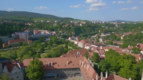 Spectacular-aerial-top-view-flight-city-Krumlov-Cesky-castle-on-the-hill-castlein-in-czech-republic-in-Europe,-summer-of-2023