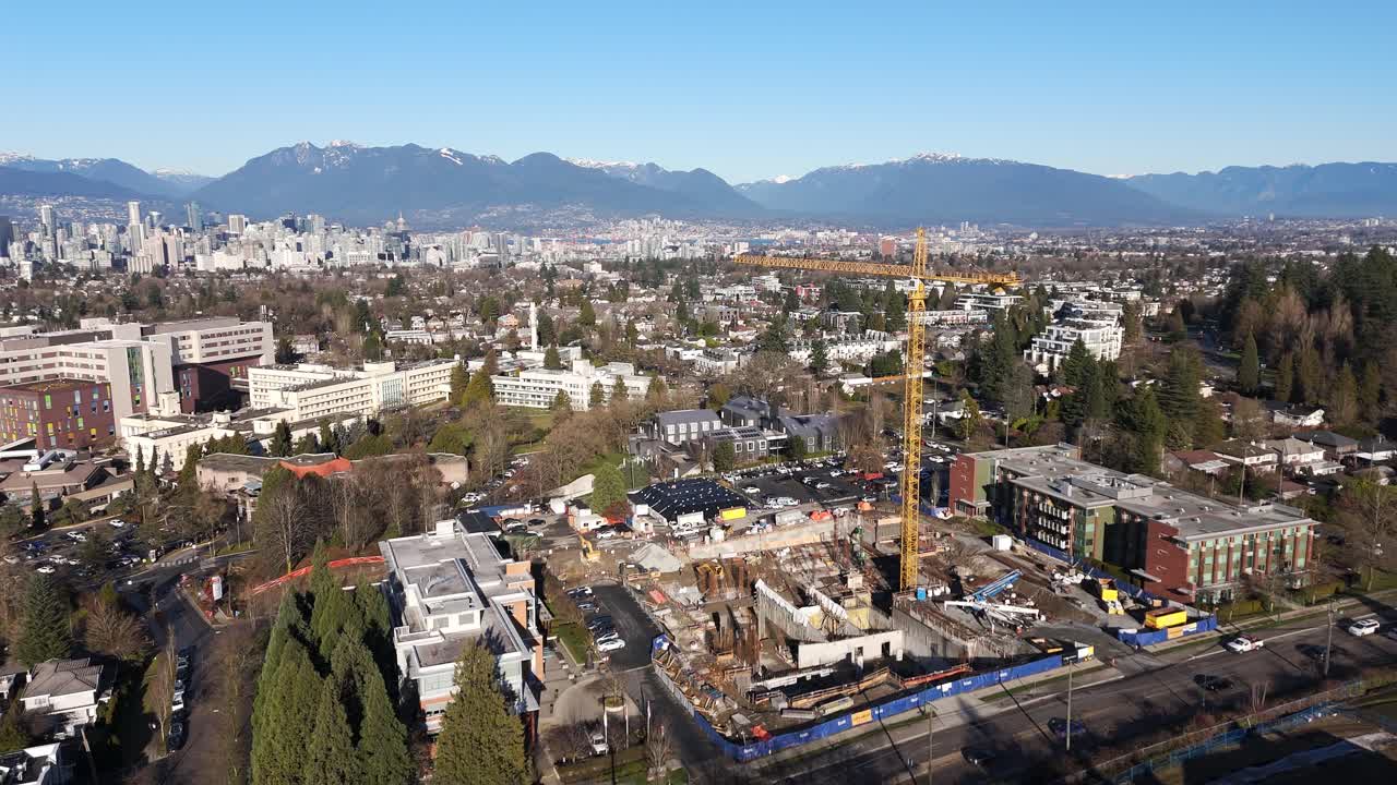 Construction Tower Crane At Building Site Near B.C. Women's Hospital And Health Centre In Vancouver, Canada. Aerial Rotate Shot