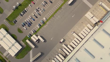 Aerial-drone-view-of-group-of-large-modern-industrial-warehouse-or-factory-buildings-in-suburban-city-area