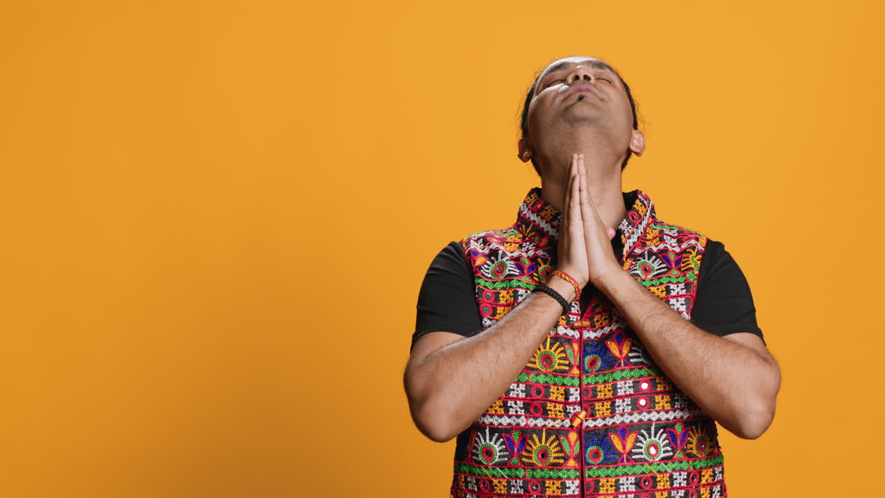 Man putting hands together to make with, studio background