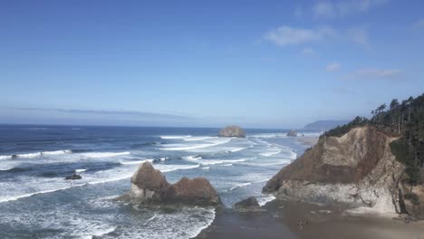 the remains of an eroded point jut out along a rugged coastline, oregon, aerial