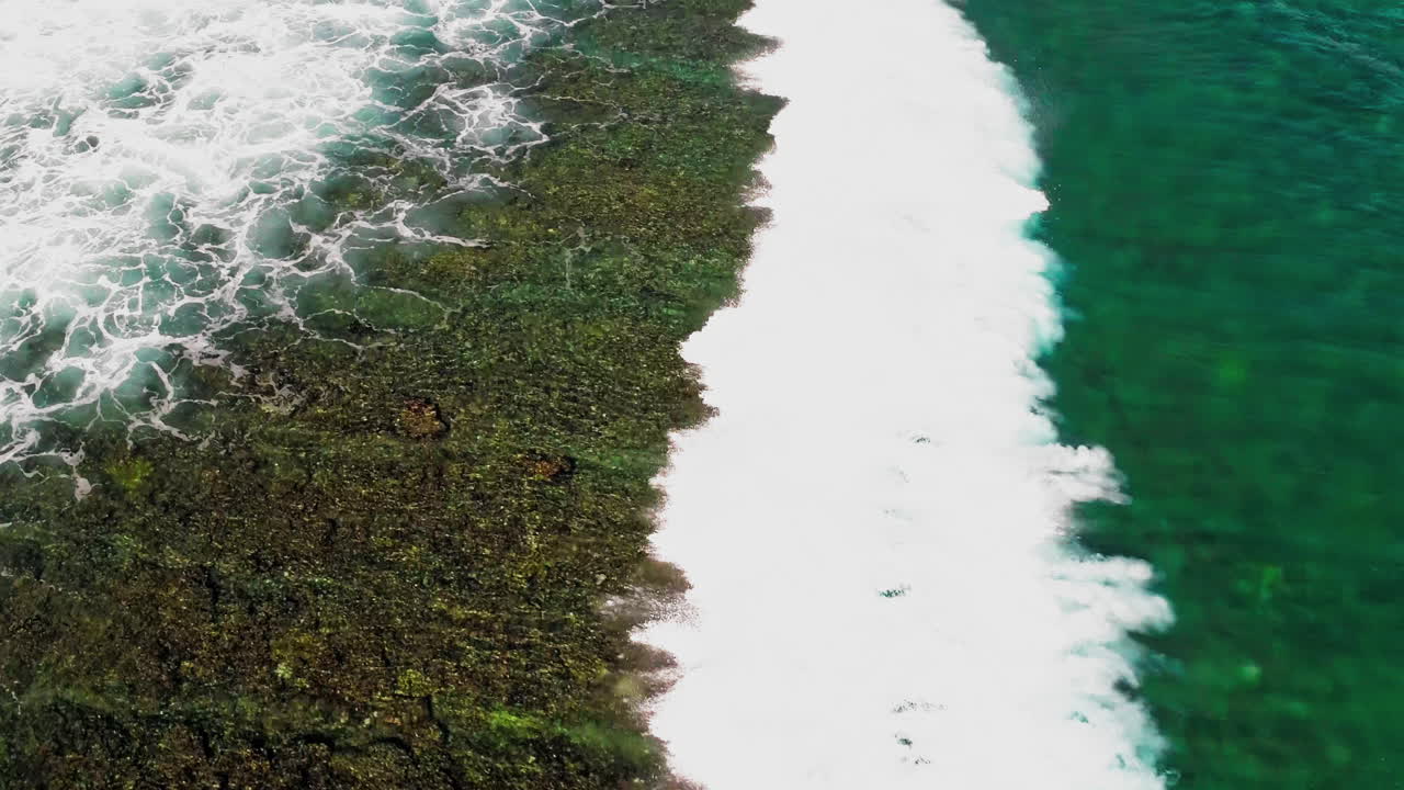 Stunning aerial footage of the Gili Islands, Indonesia. Crystal-clear waters, white sand beaches, coral reefs, and boats in paradise. Ideal for travel, nature, and tropical themes