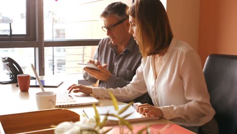 Business-people-using-digital-tablet-and-laptop