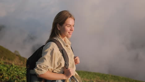 woman hiking in mountains at sunrise/sunset