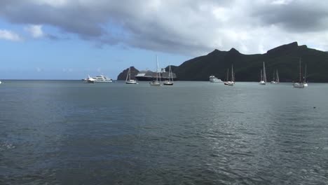 cruise ship, small yachts and sailboats in taiohae bay, nuku hiva, marquesas islands, french polynesia