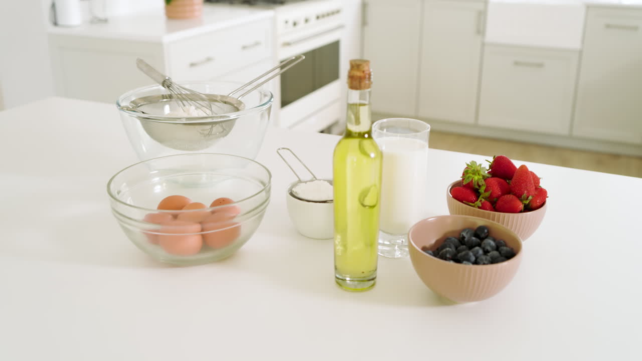 Fresh ingredients and kitchen tools ready for cooking in bright modern kitchen, at home