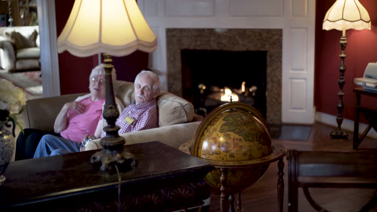 Elderly couple relaxing in their living room