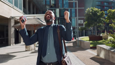excited businessman celebrating success outdoors