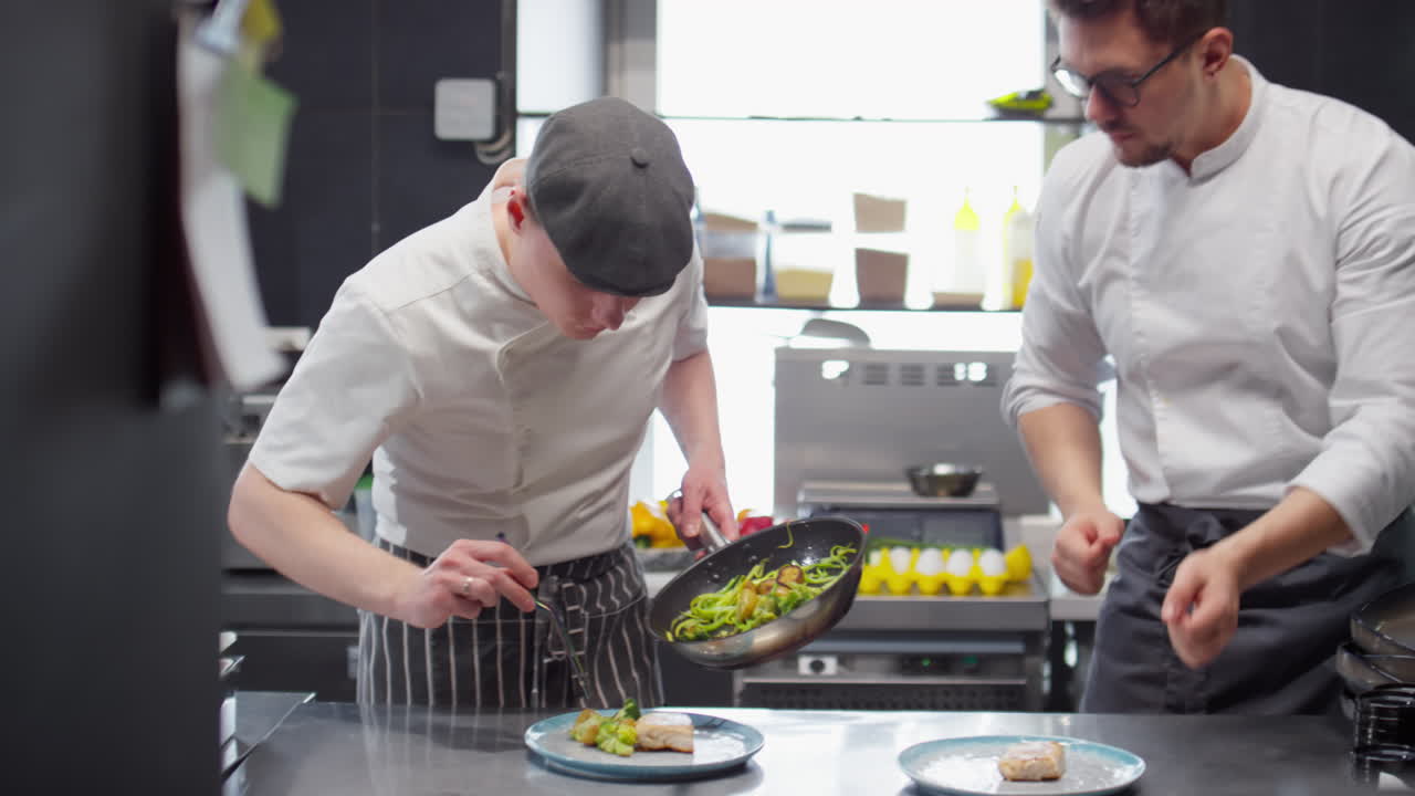Two Chefs Serving Food on Plates in Restaurant Kitchen
