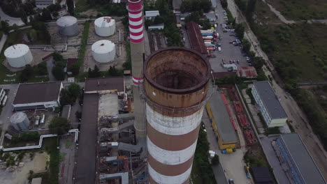circling drone shot around factory chimneys