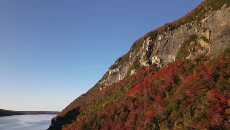 beautiful aerial drone footage of the fall leaves on and around mount hor, mount pisgah, and lake willoughby during peak autumn foliage at willoughby state forest in westmore, vermont