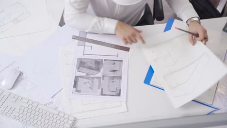 Architectural engineer is drawing the interior design of the house.