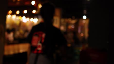 blurred view of a bustling bar interior