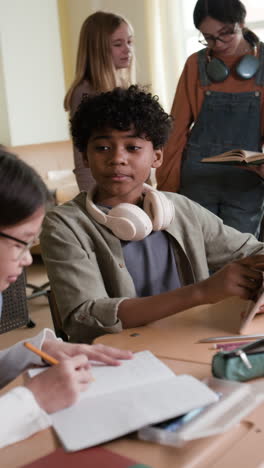 diverse group of students learning and interacting in a classroom