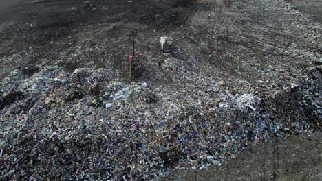 landfill site with waste piles and garbage trucks