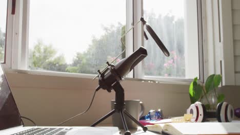 video of laptop, microphone, headphones and notepad lying on desk