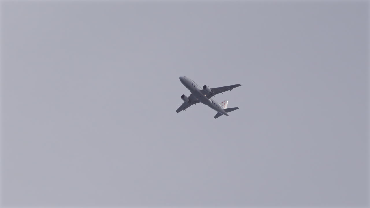 Antibes, France - May 8, 2025: View of an airplane flying on the cloudy sky in the evening