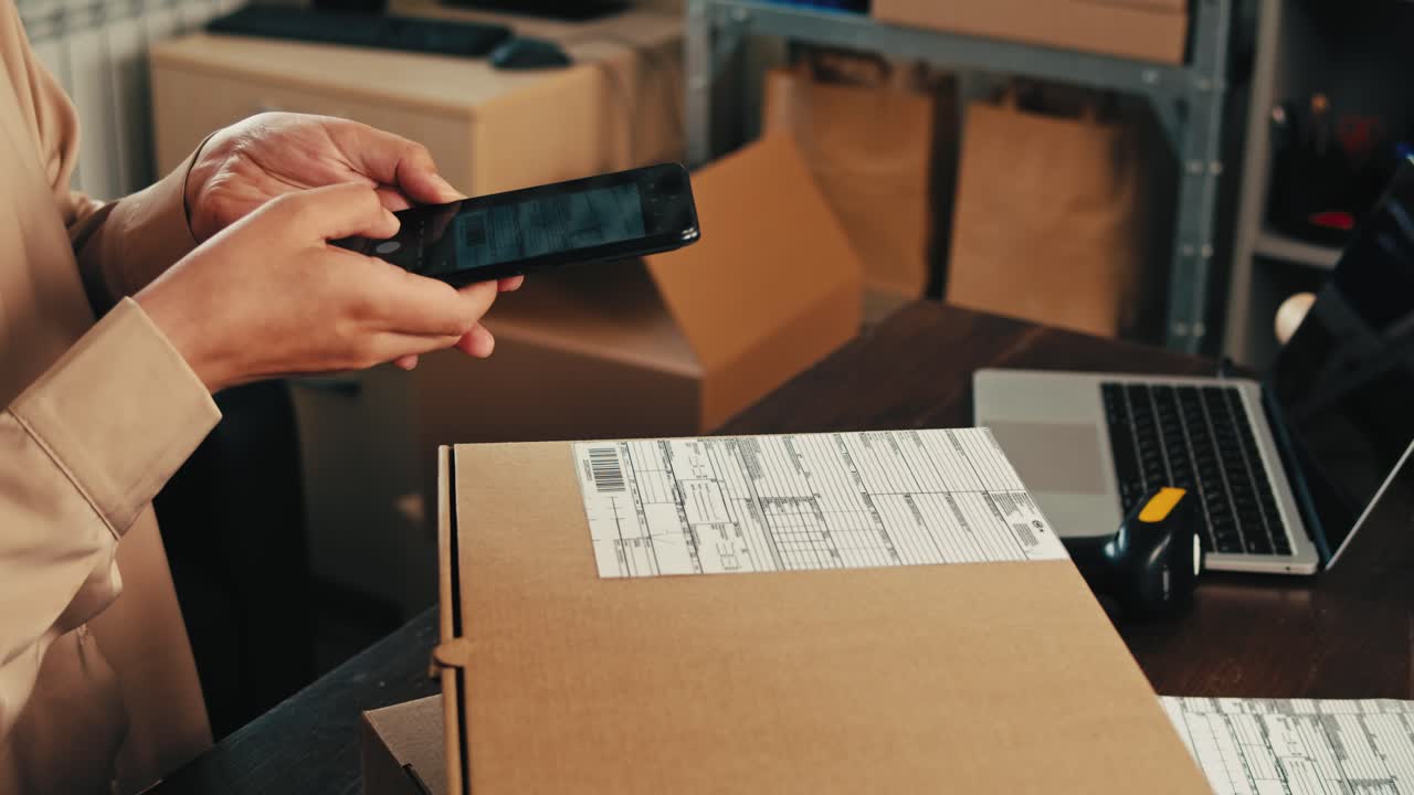 Person Scanning a Package Barcode with Smartphone