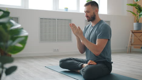 man practicing yoga meditation